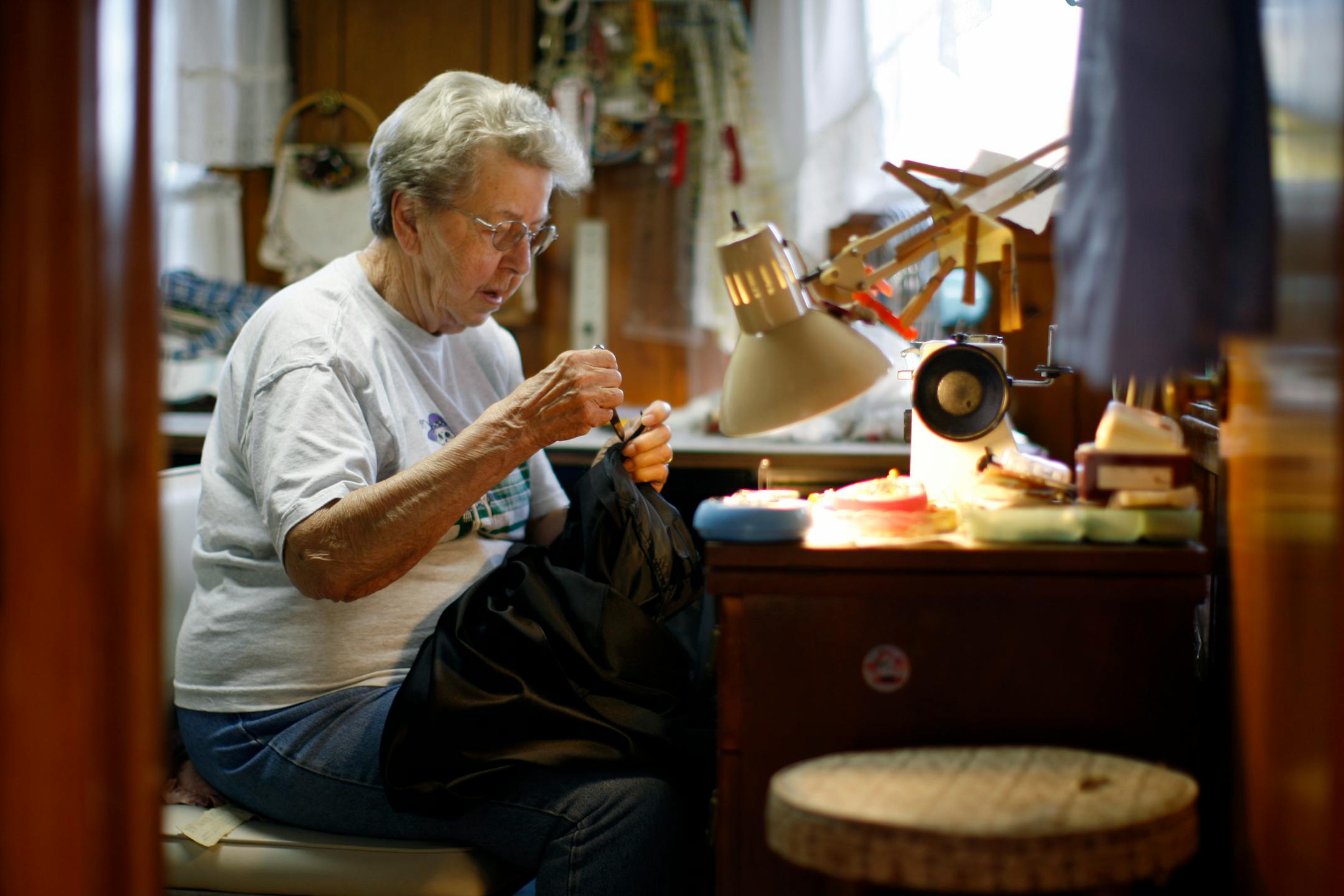 Ruth Woodstrom, 89, did some sewing work in her Andover home on Monday to bring in a little extra money. She has applied for heating aid off and on over the years and will do so this winter.