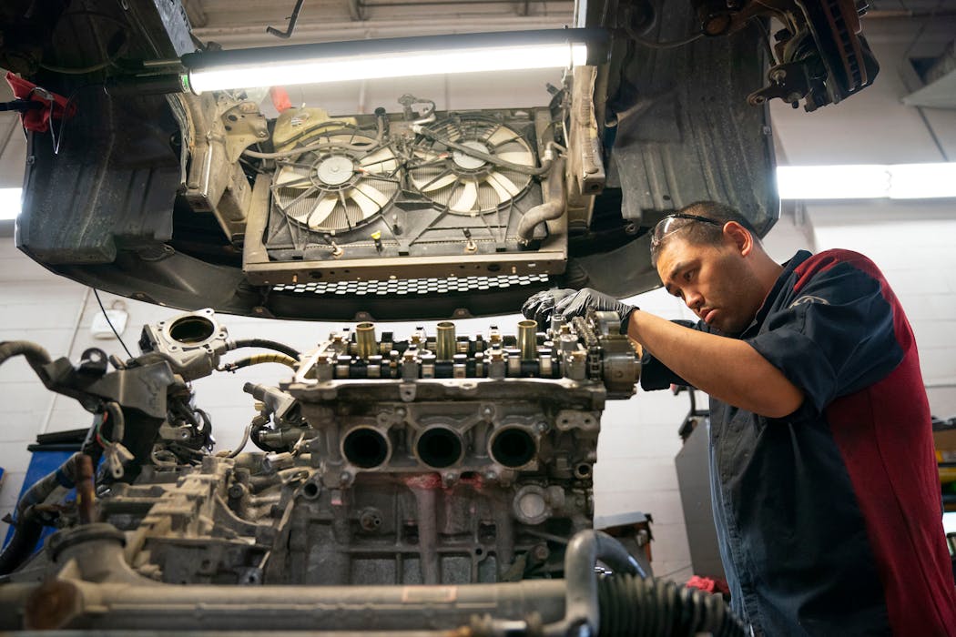 Tony Nguyen worked on an engine block at Walser Toyota. With a shortage of new cars, the dealership in Bloomington has been asking recent customers to sell back vehicles. Nguyen and his colleagues prepare used cars for resale.