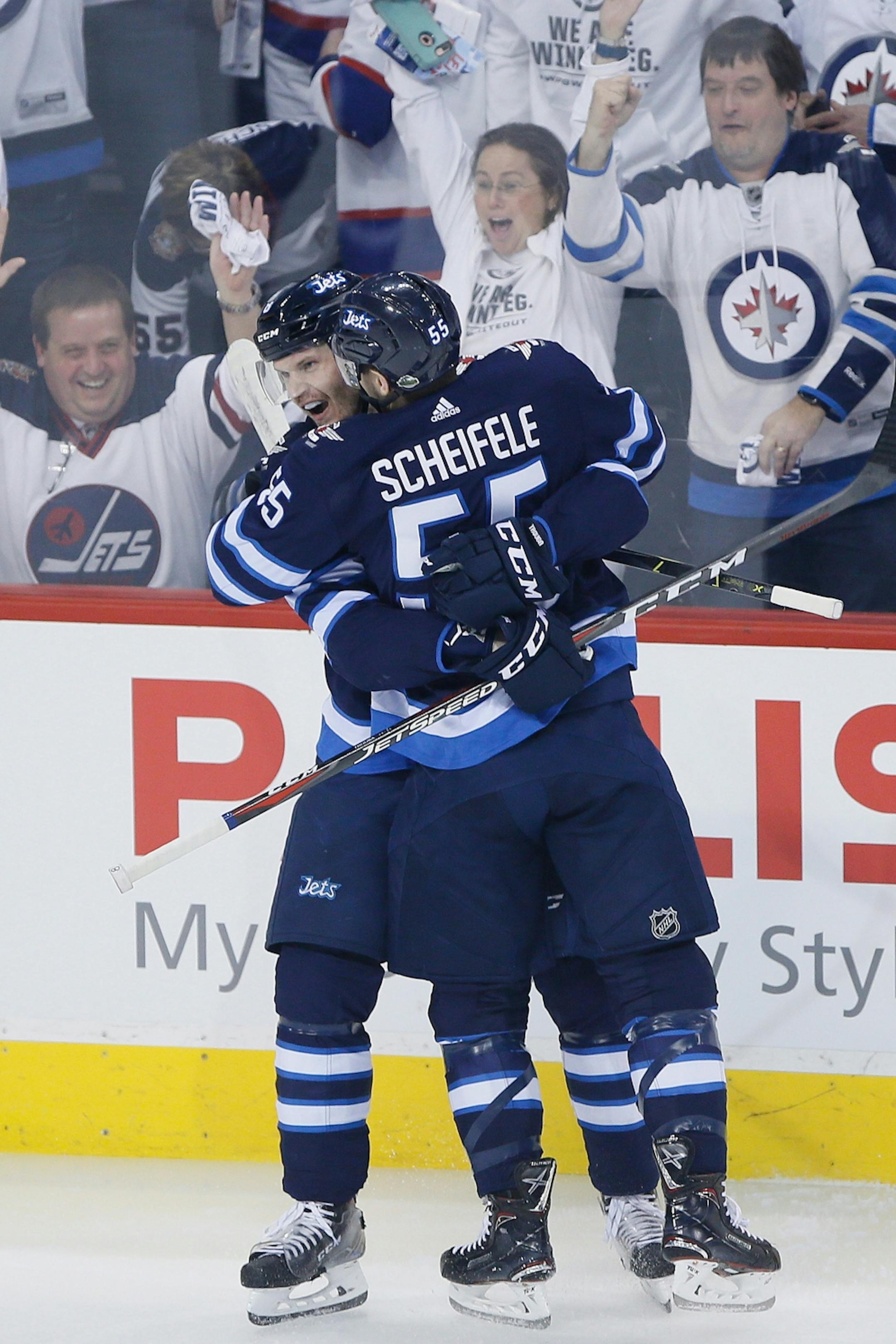 Winnipeg Jets' Jacob Trouba (8) and Mark Scheifele (55) celebrate Trouba's goal against the Minnesota Wild during the first period in Game 5 of an NHL hockey first-round playoff series in Winnipeg, Manitoba, Friday, April 20, 2018.