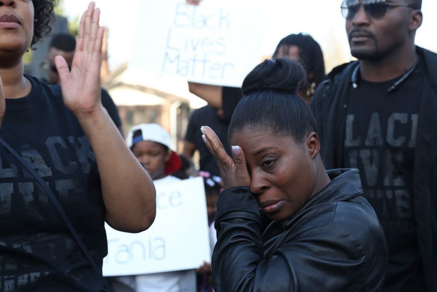 Kim Tolbert wiped the tears from her eyes as she listened to speakers before marching to North Memorial hospital to hopefully see her daughter Tania, 18, who was shot.