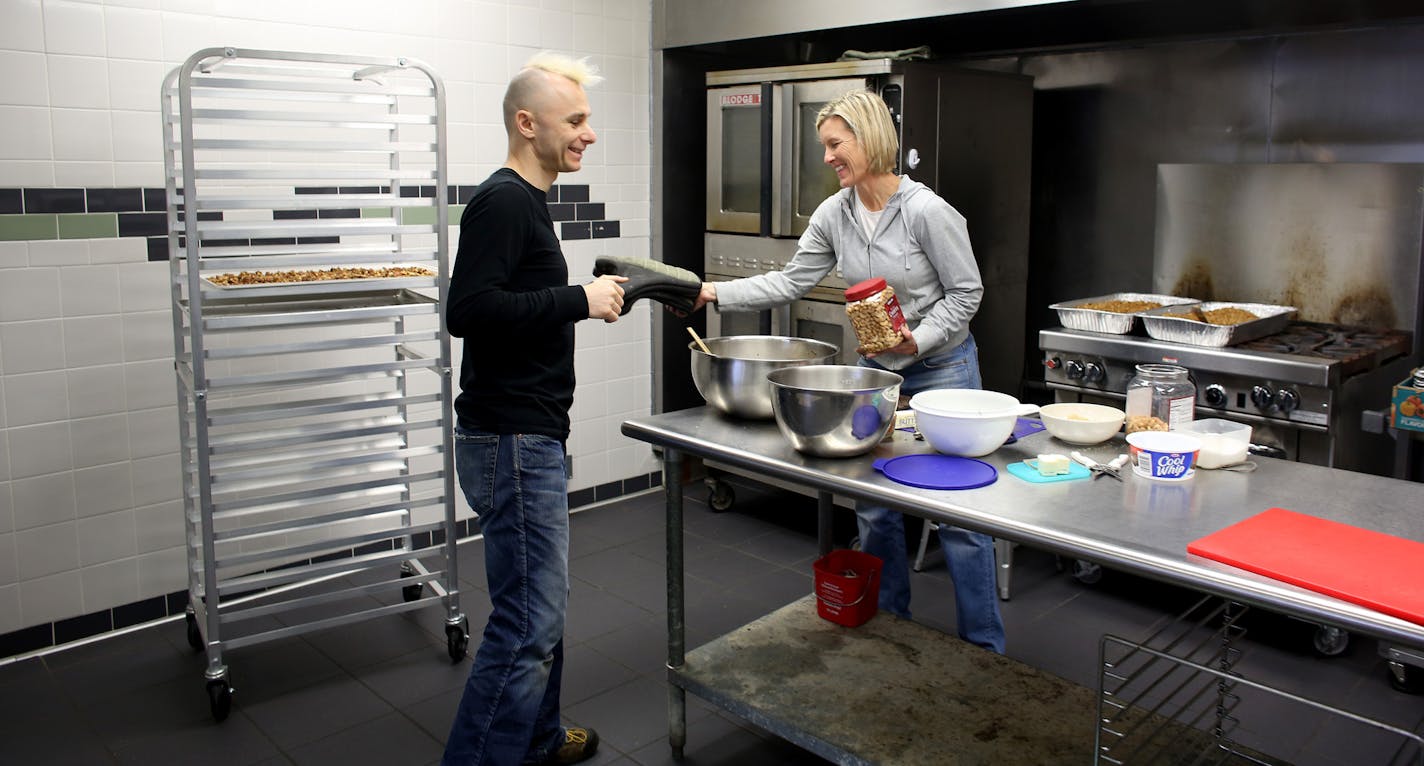 Journey Gosselin, founder of City Food Studio, handed Patti Heimbold of Patti&#x2019;s Granola oven mitts while she was using the commercial kitchen.