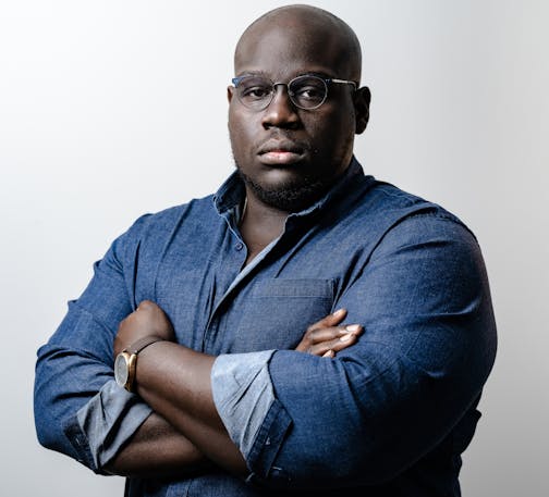 photo of author Caleb Gayle in a blue button-down shirt