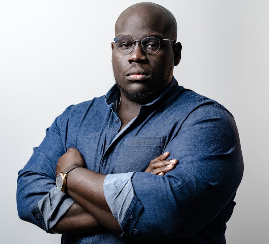 photo of author Caleb Gayle in a blue button-down shirt
