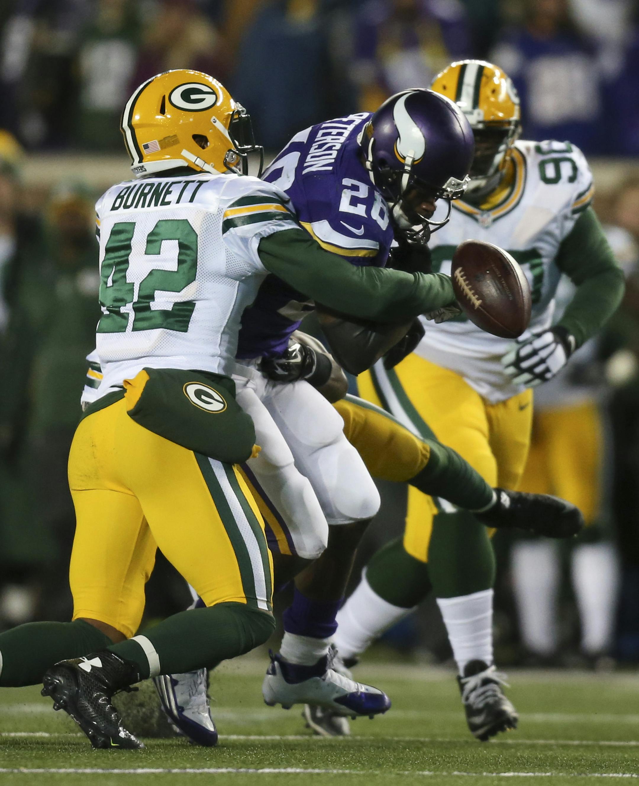 Vikings running back Adrian Peterson (28) coughed up the ball as he was tackled by Green Bay Packers strong safety Morgan Burnett (42) after gaining 10 yadds in the fourth quarter Sunday afternoon. Green Bay recovered the ball. ] JEFF WHEELER ï jeff.wheeler@startribune.com The Minnesota Vikings lost to the Green Bay Packers 30-13 in an NFL football league game Sunday afternoon, November 22, 2015 at TCF Bank Stadium in Minneapolis.
