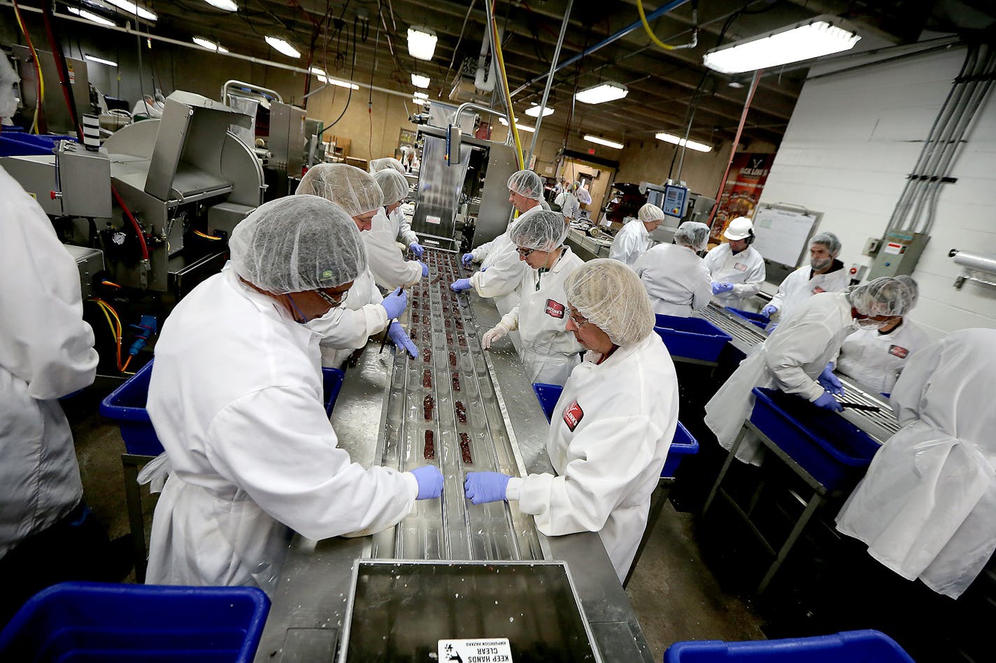 Workers processed Jack Links beef jerky in the packaging area.