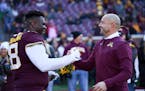Minnesota Gophers head coach P.J. Fleck greets Minnesota Gophers defensive lineman Micah Dew-Treadway (18) during a senior day ceremony before the sta