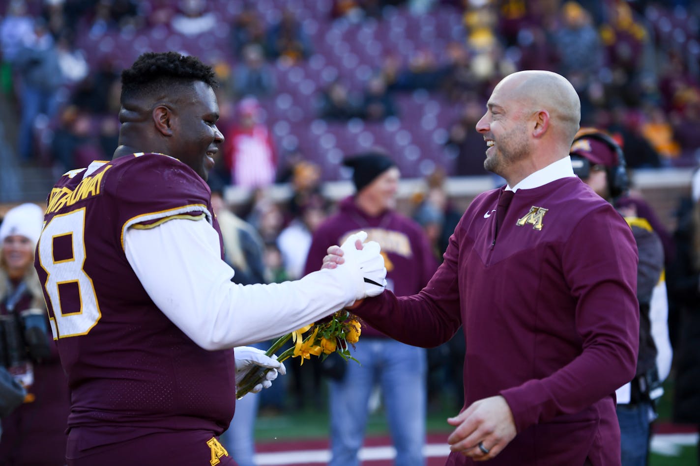 Minnesota Gophers head coach P.J. Fleck greets Minnesota Gophers defensive lineman Micah Dew-Treadway (18) during a senior day ceremony before the start of an NCAA football game between the Gophers and the Wisconsin Badgers Saturday, Nov. 27, 2021 at Huntington Bank Stadium in Minneapolis, Minn. Minnesota defeated Wisconsin 23-13. ] AARON LAVINSKY • aaron.lavinsky@startribune.com