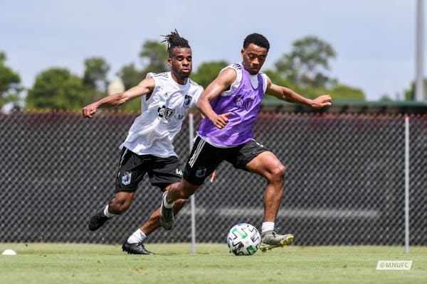 Jacori Hayes controlling the ball with Raheem Edwards defending from behind. Both are new midfielders acquired for this season. They're training at ES