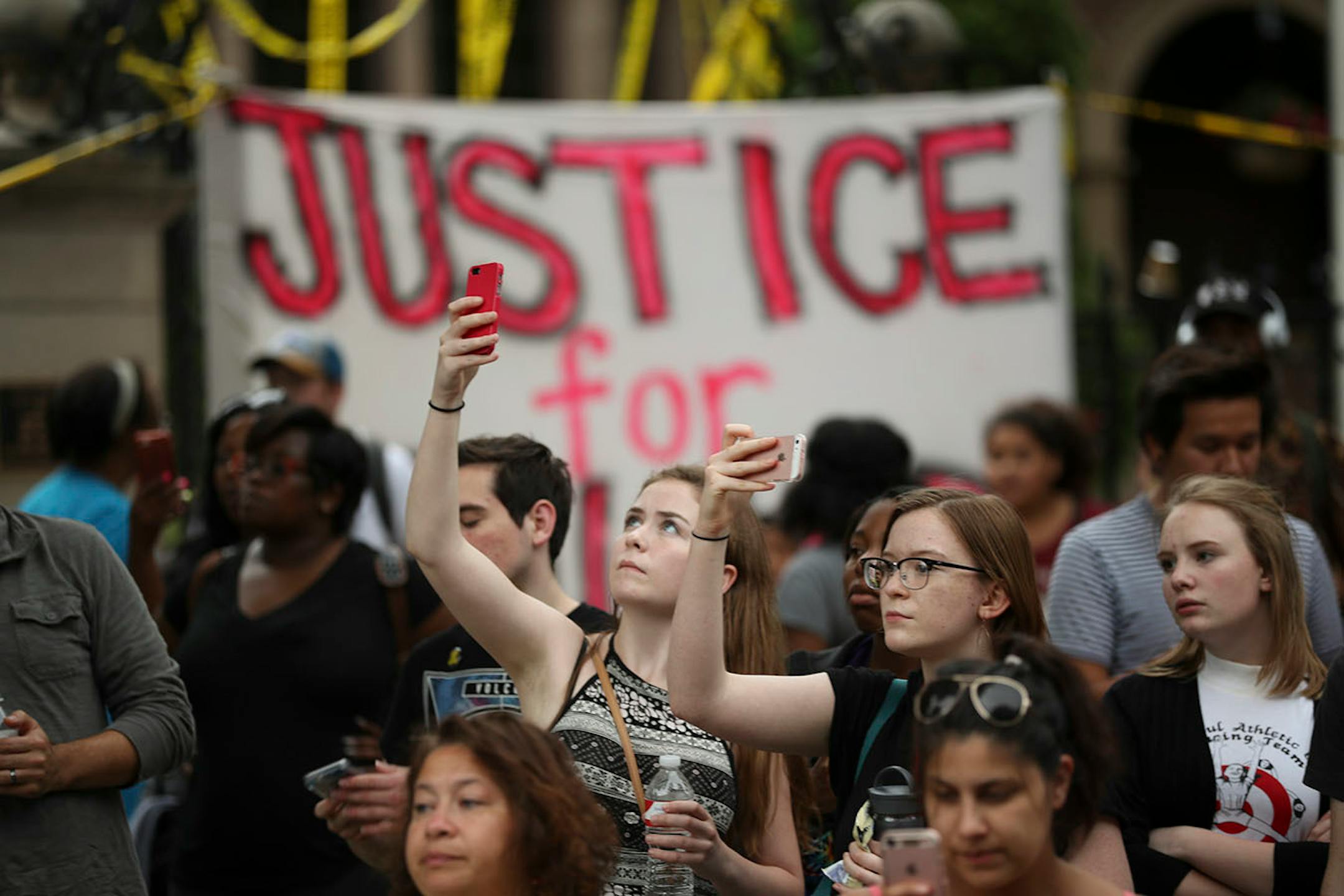 People watched as marchers arrived at the Governor's Mansion after a vigil for Philando Castile at the school where he worked.