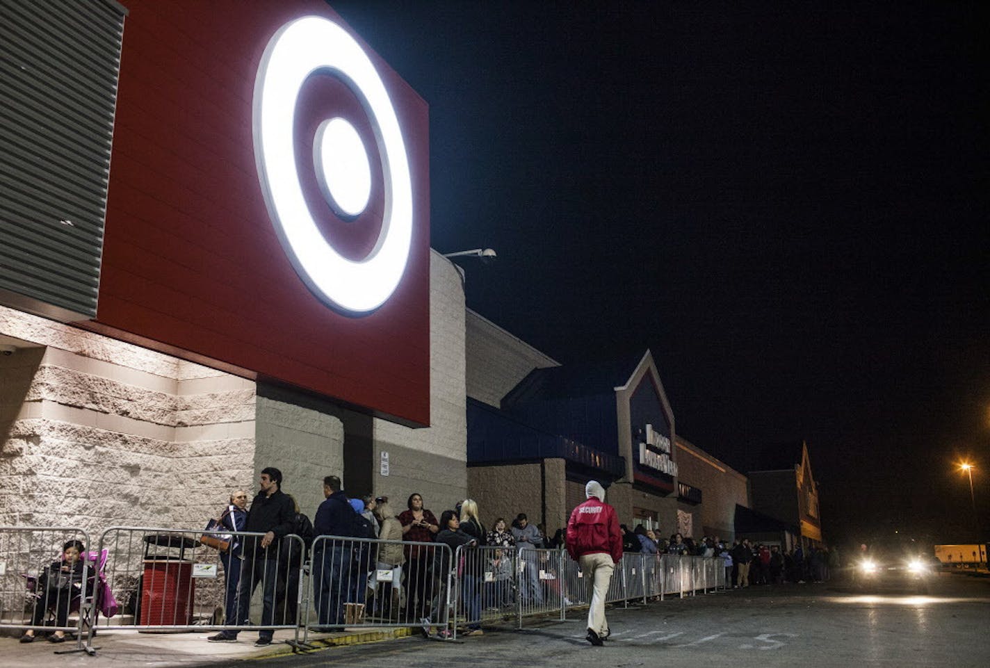 People stand in line for Black Friday shopping at Target Thursday, Nov. 24, 2016, in Bowling Green, Ky. After enjoying the Thanksgiving turkey, some Americans hit the stores for what retailers hope will be a new tradition to start the holiday shopping season. (Austin Anthony/Daily News via AP)