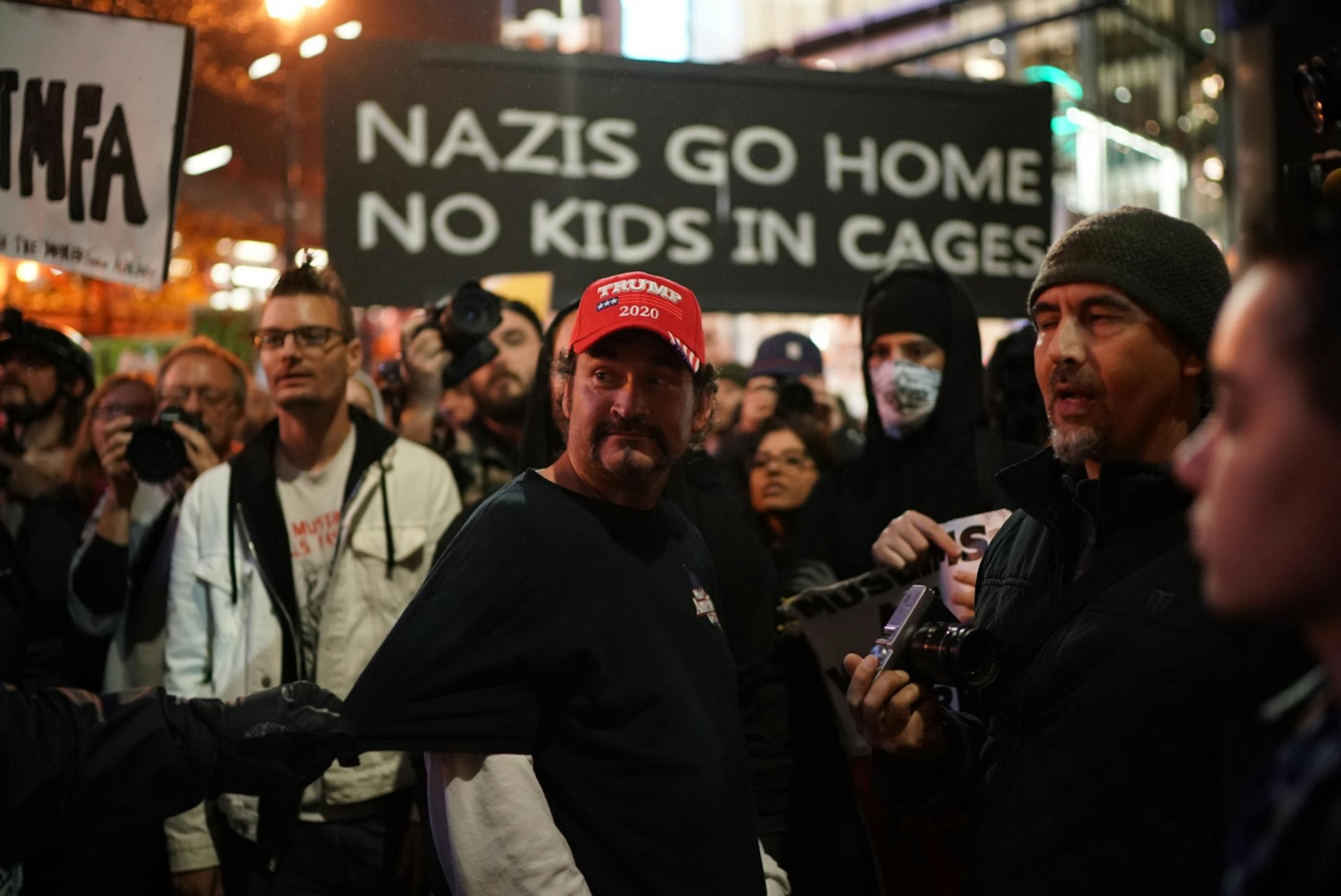 Trump supporter pulled away from Antifa outside Target Center.