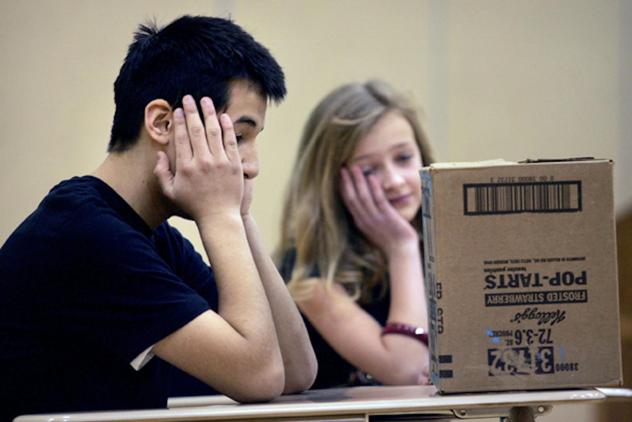 Seventh-graders Mitch Bermel, left, and Chandler Larson expressed frustration with their school's aging computers during a skit they performed at the assembly. The skit was devised by the Leadership Team.