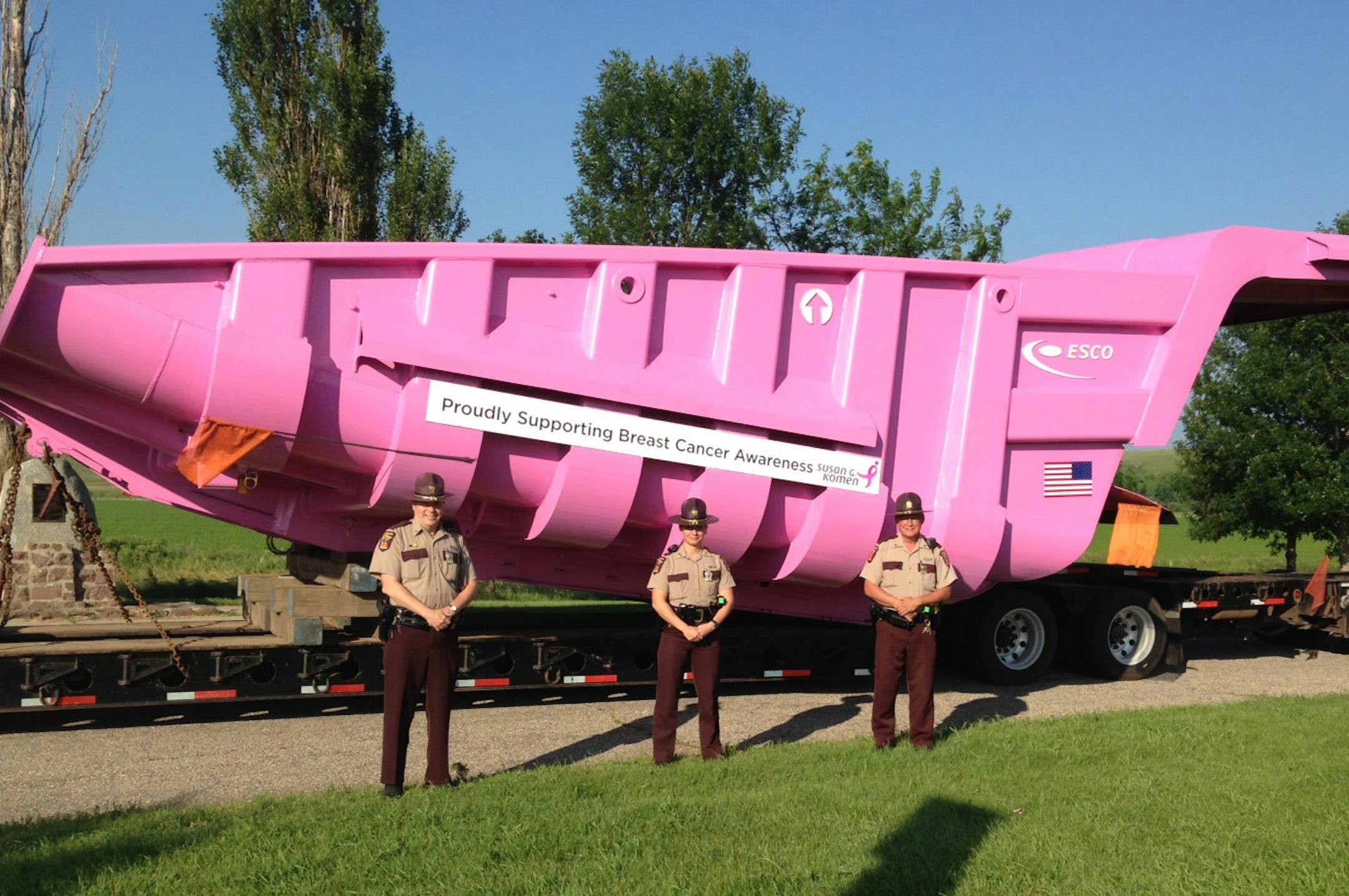 Minnesota State Patrol troopers stood with the 83,000-pound breast cancer awareness campaign symbol that they helped escort to the Hibbing Taconite Co. mine in Hibbing.