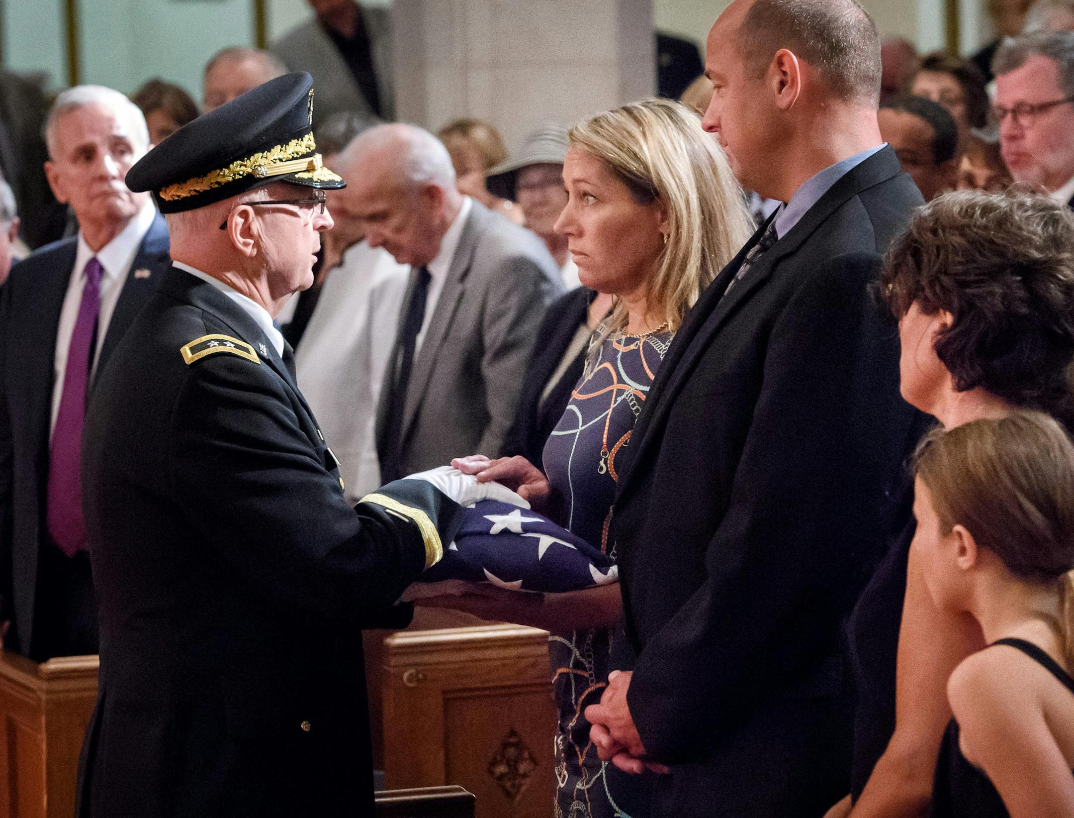 Minnesota National Guard Major General Rick Nash presented an American Flag to former Gov. Wendell Anderson's daughter Amy for Anderson's service in the Army and as Commander of the Guard. ] GLEN STUBBE * gstubbe@startribune.com Monday, August 15, 2016 Former Gov. Wendell Anderson's funeral was held Monday at Mount Olivet Lutheran Church, Minneapolis. EDS, to the right are Amy's boyfriend Keith Larson, gov. Anderson's daughter Beth Crowe.