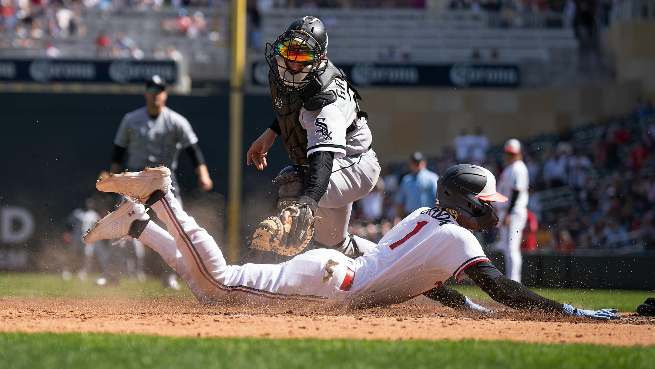 Minnesota Twins second baseman Nick Gordon slid under the tag of Chicago White Sox catcher Yasmani Grandal for a fifth inning run.