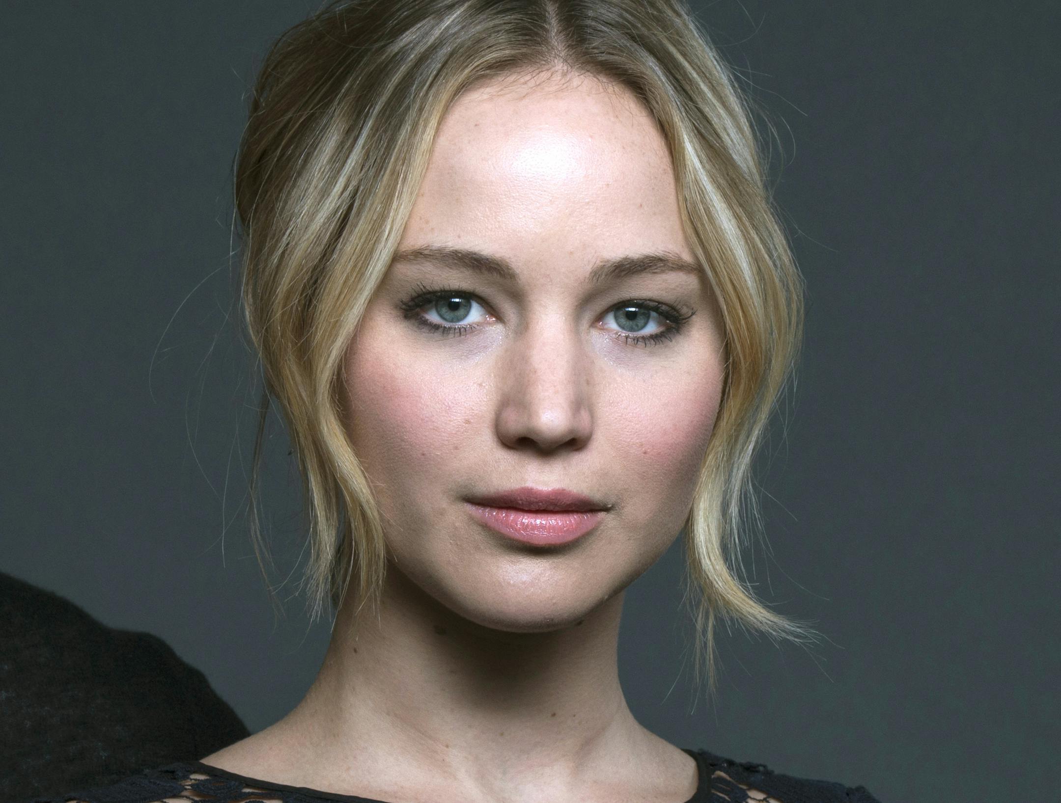 In this Nov. 15, 2014 photo, cast members in "The Hunger Games: Mockingjay - Part 1" from left, Liam Hemsworth, Jennifer Lawrence and Josh Hutcherson pose for a portrait in New York. (Photo by Drew Gurian/Invision/AP)