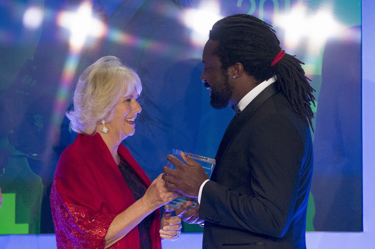 Britain's Camilla, Duchess of Cornwall presents the trophy to Marlon James, author of "A Brief History of Severn Killings", after he was named as the winner of the Man Booker Prize for Fiction 2015, in London, Tuesday Oct. 13, 2015. Marlon James became the first Jamaican winner of the prestigious Booker Prize for fiction Tuesday with a vivid, violent, exuberant and expletive-laden novel based on the 1976 attempted assassination of Bob Marley. (Neil Hall/Pool via AP) ORG XMIT: MIN2015101319140811