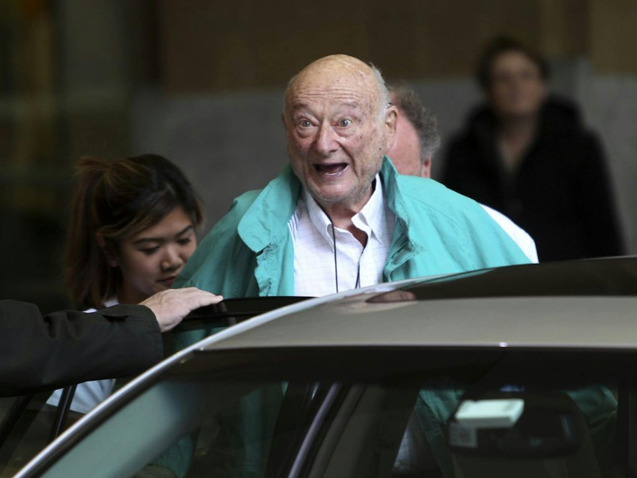 In December, former New York City Mayor Ed Koch says good-bye to reporters as he gets in his car after being released from the hospital in New York. He was readmitted with pneumonia and the flu.