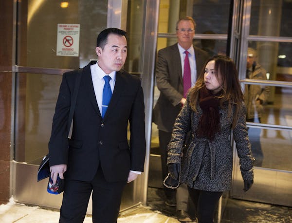 Koua Fong Lee, left, his wife Panghoua Moua and their attorney Bob Hilliard walk out of the Federal Courthouse in Minneapolis on Thursday, January 8, 