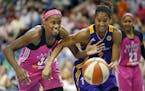 Sylvia Fowlers left tried to steal the ball from Candace Parker of the Sparks in the second half. Minnesota Lynx beat the Los Angles Sparks 72-64 at T