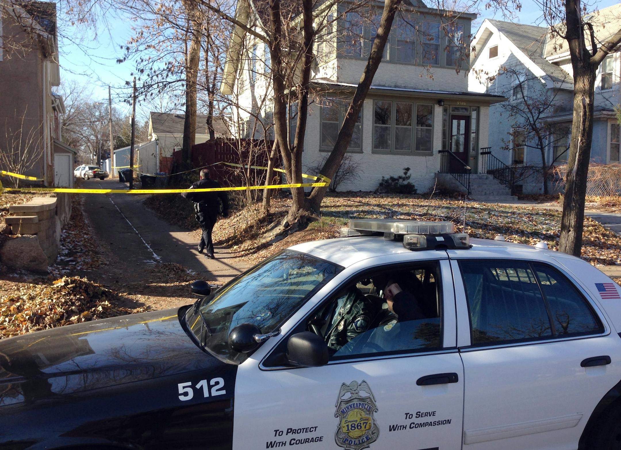 Police officers investigate a homicide in an alley south of W. 39th Street between Blaisdell and Pillsbury Avenues in south Minneapolis on Friday, Nov. 22, 2013.