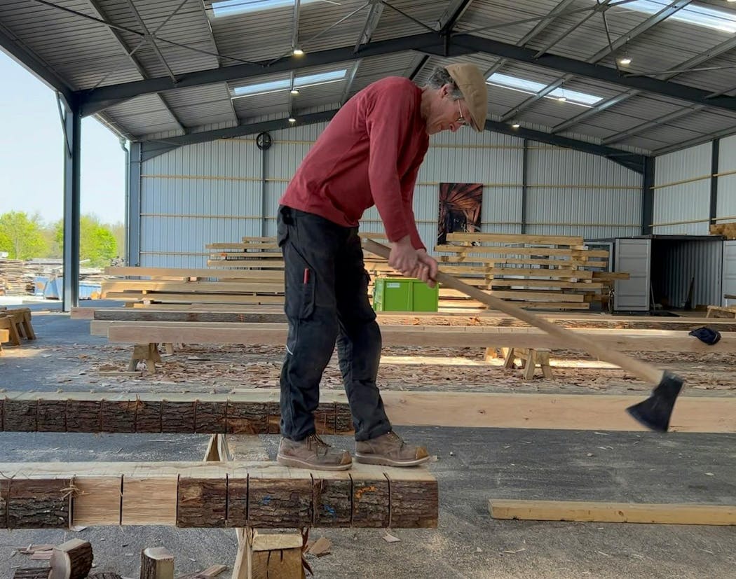 Peter Henrikson works on an oak log in France earlier this year.