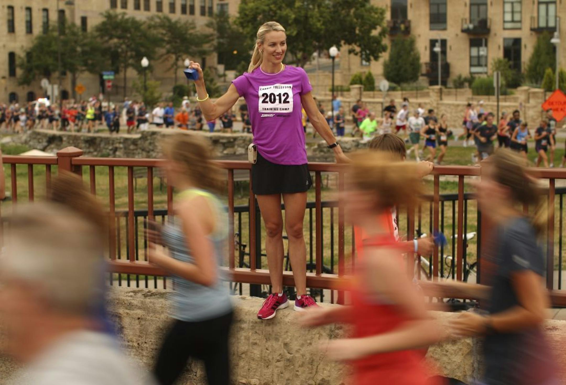Carrie Tollefson, the 2004 U.S. Olympic distance runner, cheered on runners competing in Minneapolis Aquatennial's Life Time Torchlight 5K in 2012. She was running a camp hosted the Carrie Tollefson Training Camp for runners in grades 7-12.