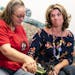 Brooke Eaton, right, and Margaret Bond Vorel listened to a recording of the heartbeat of Eaton's son Cazmirr "Cash" Landers, who's heart was donated t