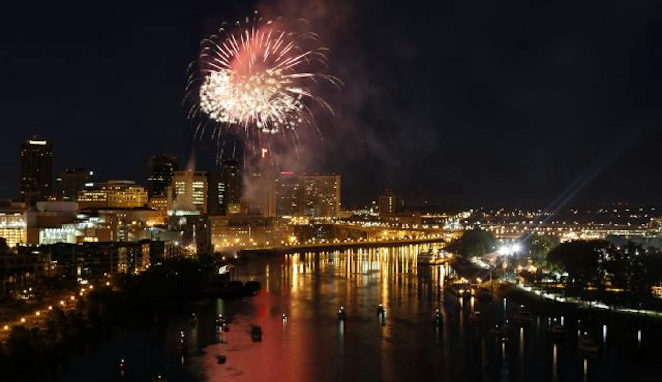 Fireworks light up the Mississippi River as patrons watch from both boats as well as the fair grounds during the 2009 Taste of Minnesota Thursday evening on Harriet Island in St. Paul.
