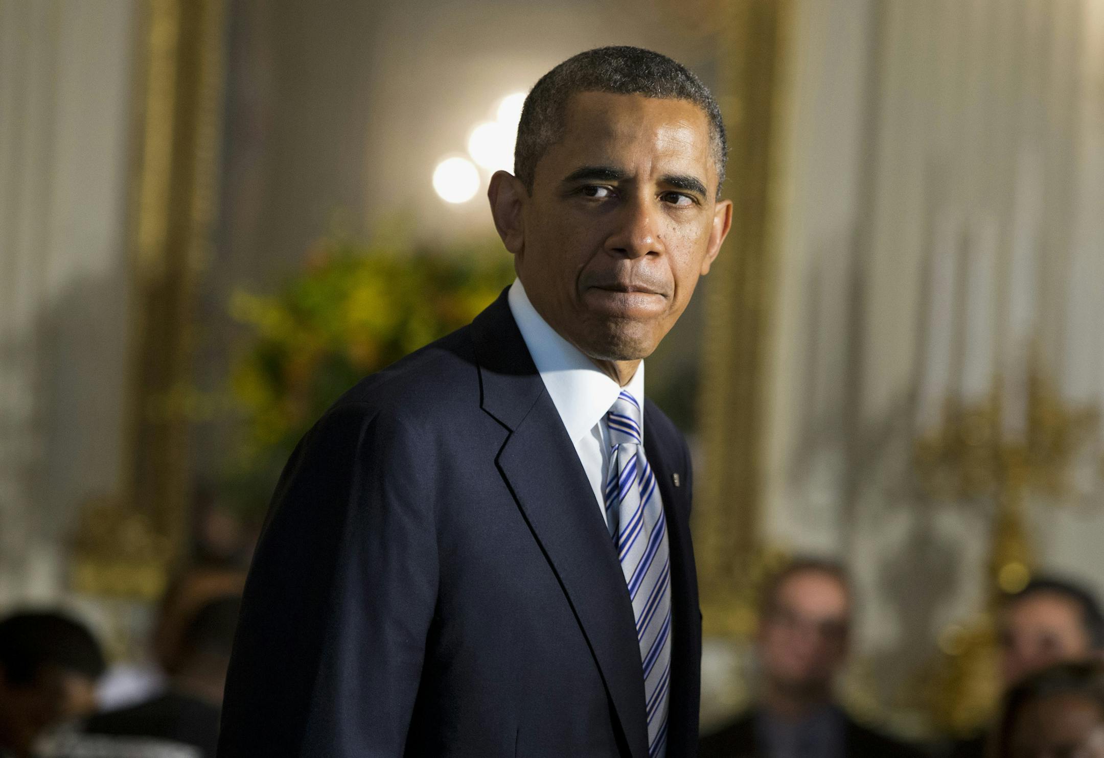 President Barack Obama arrives in the State Dining Room of the White House in Washington, Friday, June 14, 2013.