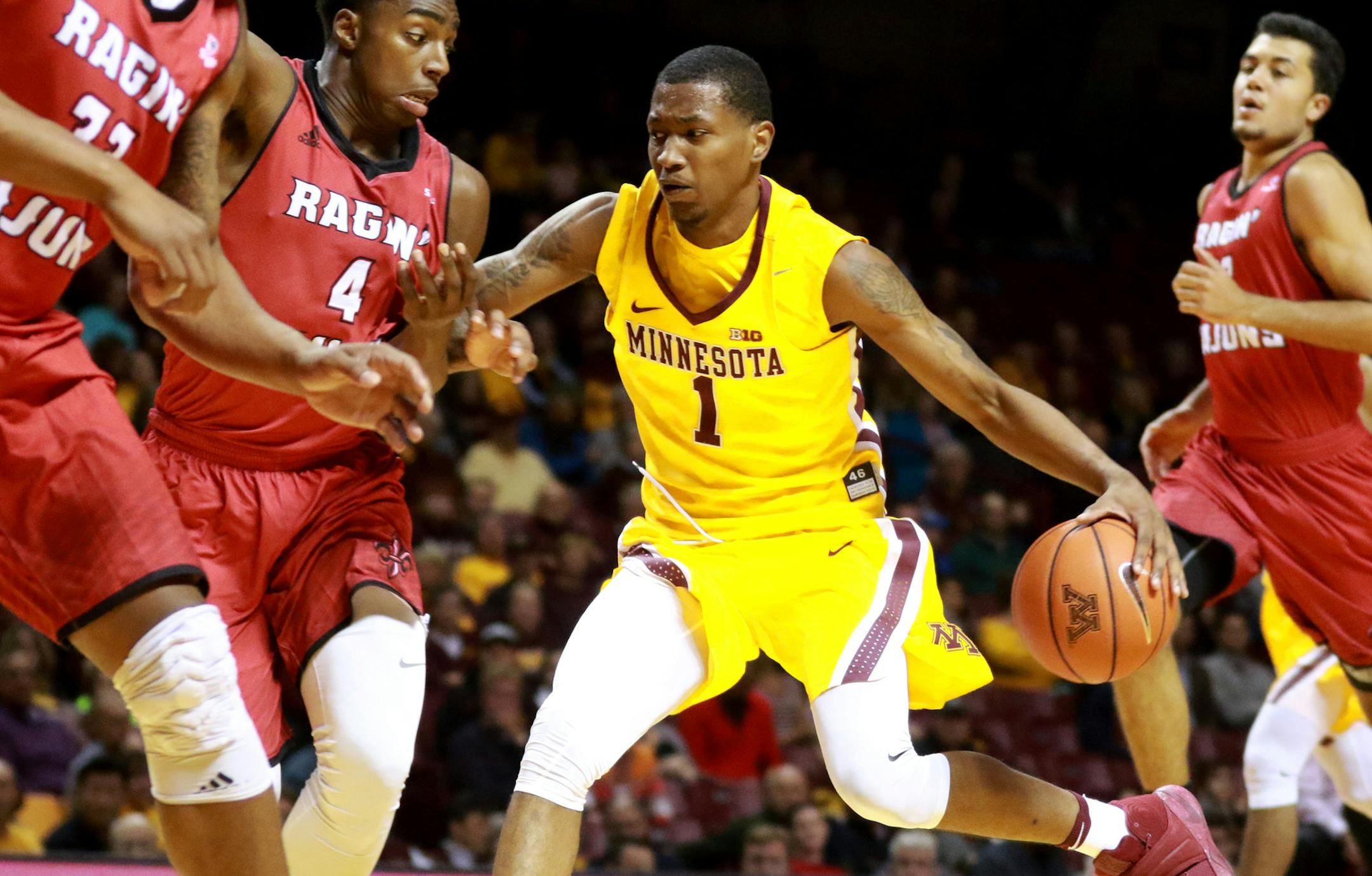 The University of Minnesota's Dupree McBrayer (1) is guarded by La.-Lafayette's Frank Bartley (4) while driving to the basket during the second half of the Gophers 86-74 win Friday, Nov. 11, 2016, at Williams Arena on the University of Minnesota campus in Minneapolis, MN.] (DAVID JOLES/STARTRIBUNE)djoles@startribune.com Gophers game vs. La.-Lafayette