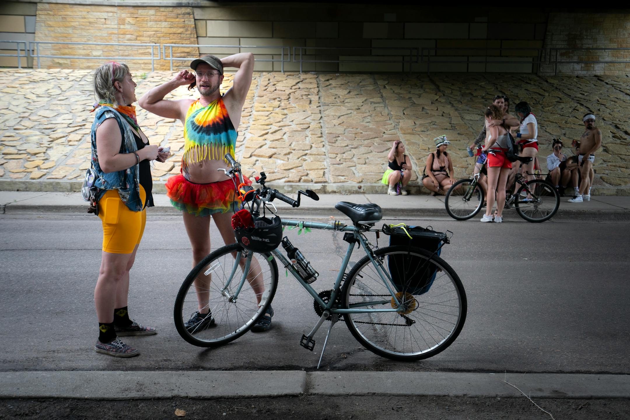 Casi Brink and Anthony Art get ready for the annual Freedom From Pants Ride in Minneapolis on Tuesday, July 4, 2023. The ride is always held on Independence Day to celebrate freedom in a unique way – by freedom from standard clothes. This year's ride started on Nicollet Island under the Hennepin Avenue Bridge, went through Loring Park, and ended at the Martin Olav Sabo Bridge.