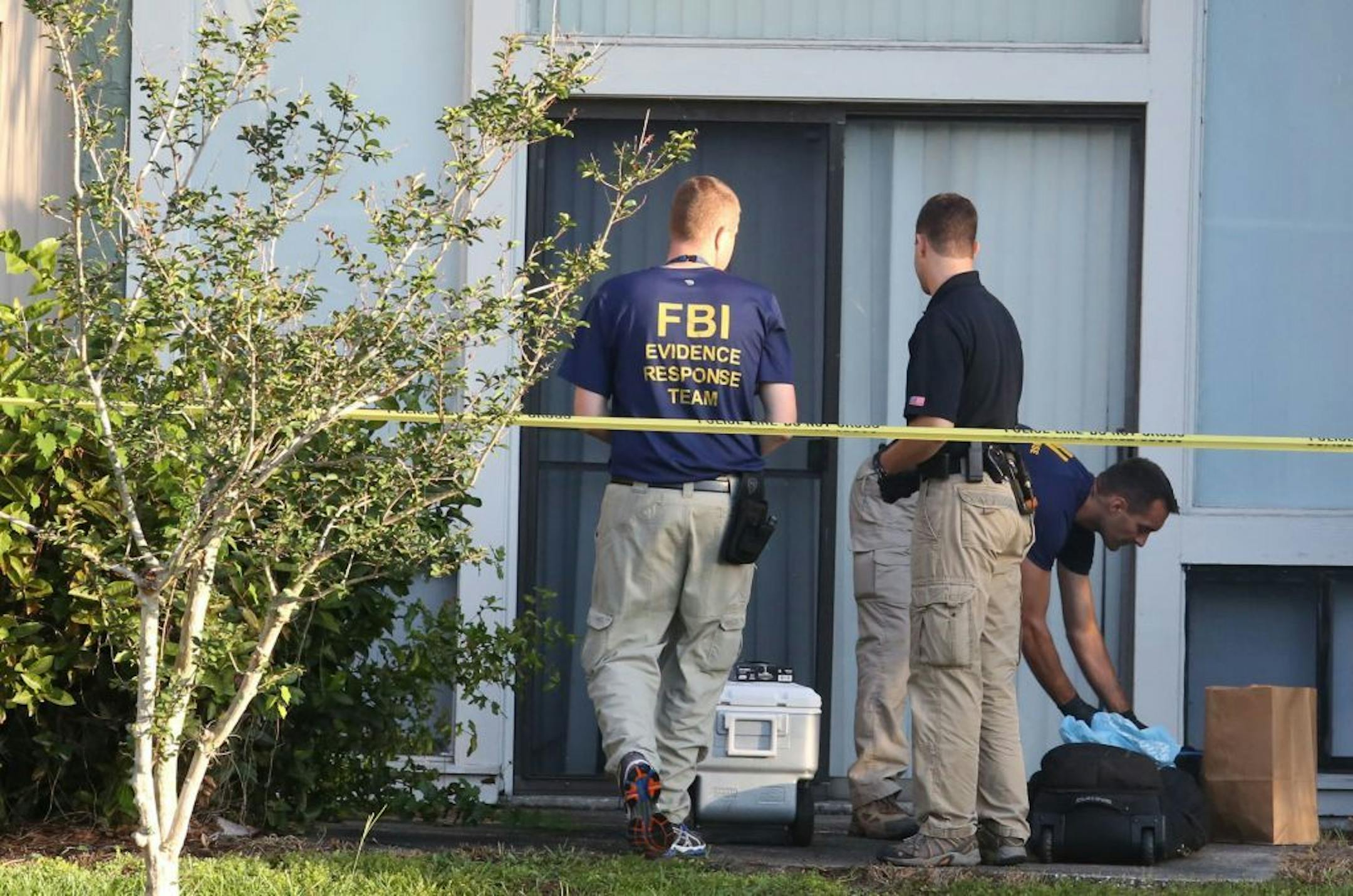 FBI evidence response team gather in front of an apartment Wednesday, May 22, 2013 in Orlando, Florida, after an FBI agent shot and killed a man who was questioned in connection with the Boston Marathon bombings.