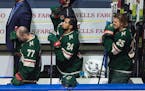 The Wild's Matt Dumba stands with fist raised during the national anthem before taking on the Canucks on Thursday night.