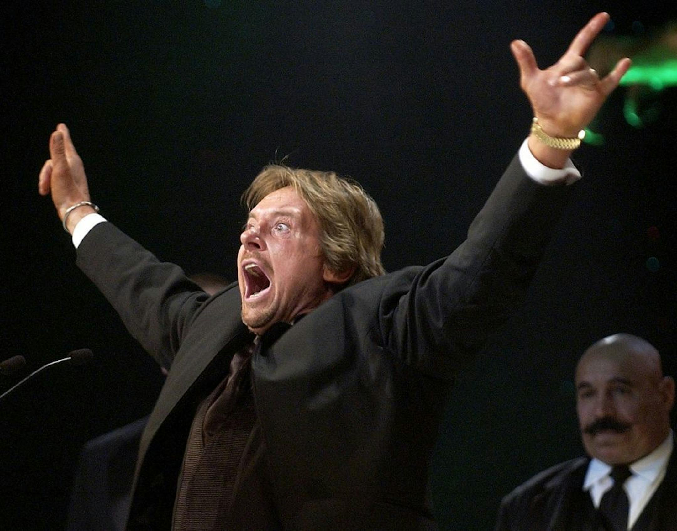 FILE - In this April 2, 2005 file photo, Wrestler Rowdy Roddy Piper gestures to the crowd after being inducted into the WWE Hall of Fame at the Induction Ceremony in Universal City, Calif. The WWE said Piper died Friday, July 31, 2015. He was 61.