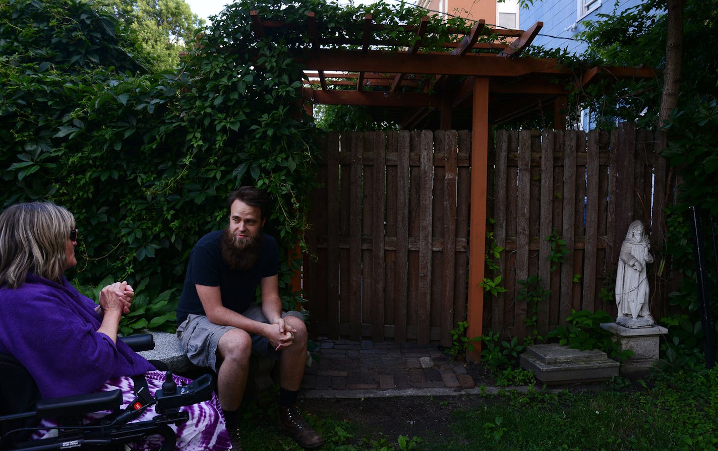 Park Avenue neighbors Andrea Crumly, left, and Jon Benson visited in Benson&#x2019;s backyard during the neighborhood&#x2019;s weekly backyard potluck that has been going since 2004.