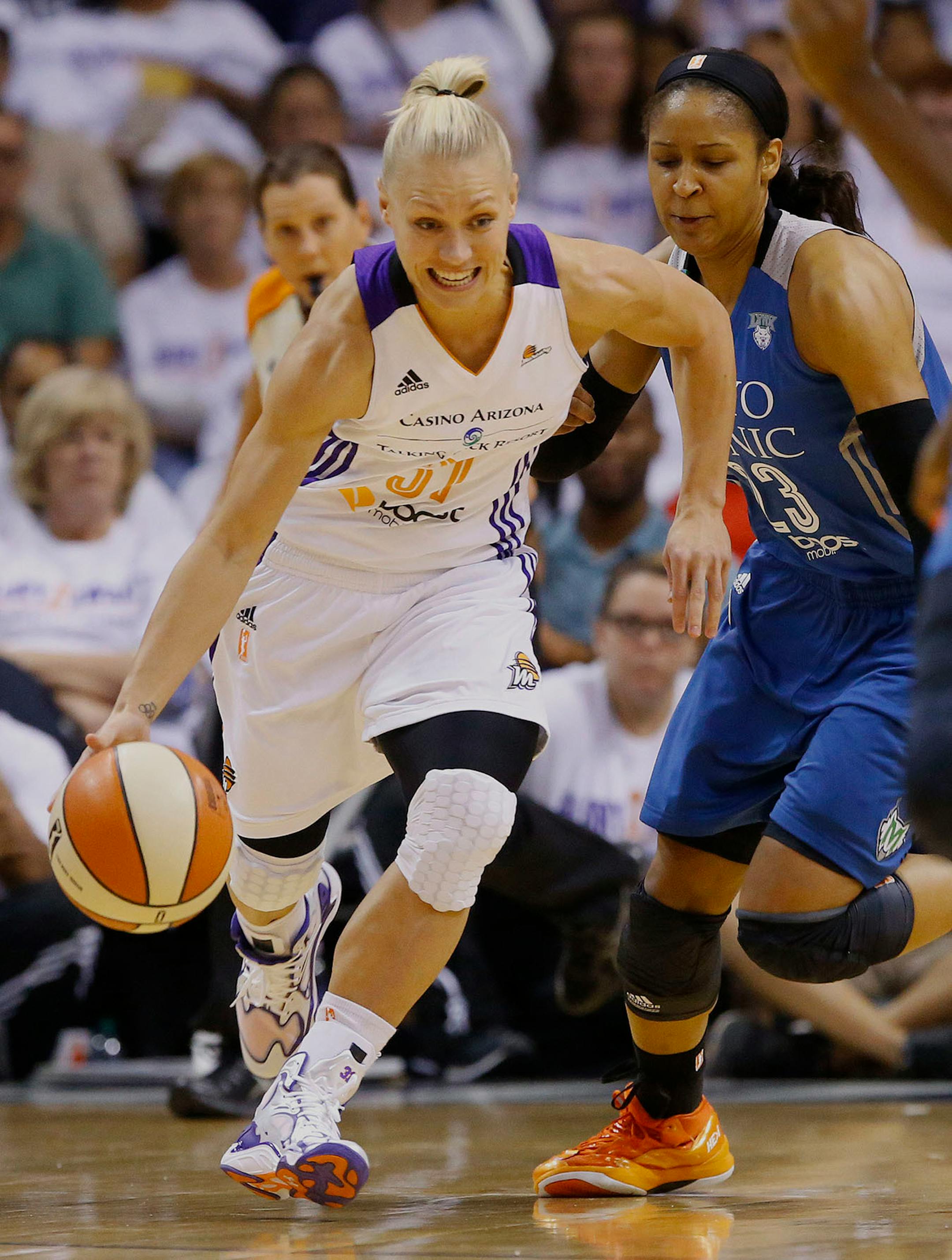 Phoenix Mercury guard Erin Phillips (31) breaks away from Minnesota Lynx forward Maya Moore (23) during the first quarter of Game 1 of the WNBA Western Conference finals Friday, Aug. 29, 2014 in Phoenix, Ariz.