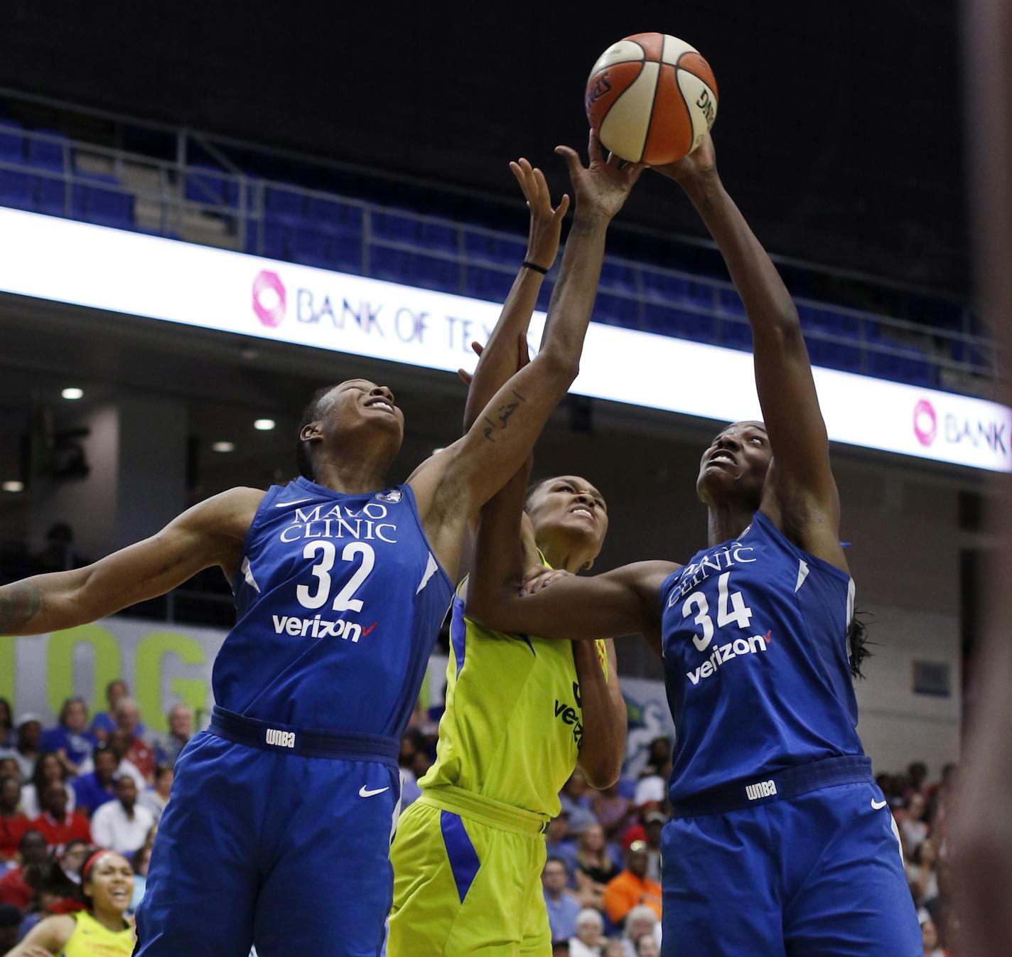 Dallas Wings forward Azura Stevens, center, battles with Minnesota Lynx defenders Rebekkah Brunson (32) and Sylvia Fowles (34) for a rebound during first-half action of a WNBA basketball game Sunday, July 1, 2018, in Arlington, Texas. (Steve Hamm/The Dallas Morning News via AP)