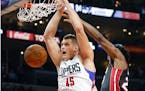 Los Angeles Clippers' Cole Aldrich, left, dunks past Miami Heat's Justise Winslow during the first half of an NBA basketball game Wednesday, Jan. 13, 