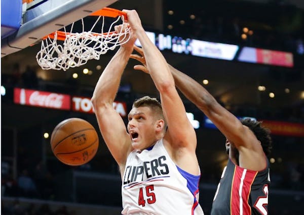 Los Angeles Clippers' Cole Aldrich, left, dunks past Miami Heat's Justise Winslow during the first half of an NBA basketball game Wednesday, Jan. 13, 