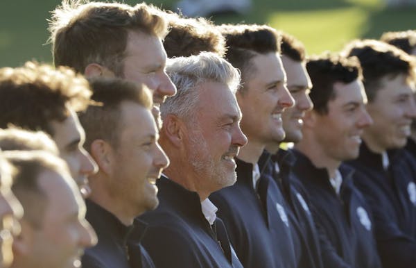 Europe captain Darren Clarke poses for a picture with his team before a practice round for the Ryder Cup golf tournament Tuesday, Sept. 27, 2016, at H