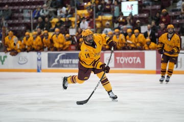 Gophers defenseman Brock Faber snaps a shot toward the Penn State goal on Friday night.