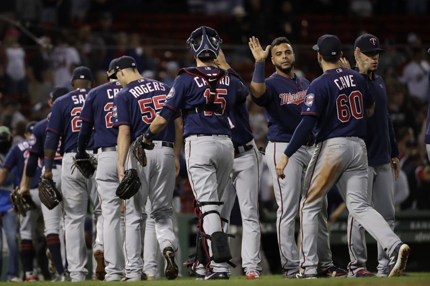 Minnesota Twins celebrate their 2-1 victory over the Boston Red Sox after a baseball game at Fenway Park, Thursday, Sept. 5, 2019, in Boston.