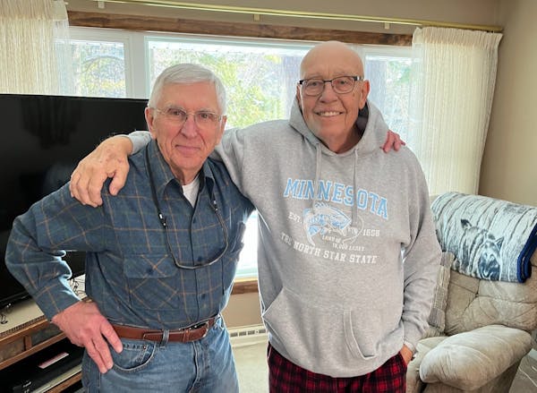 Former Minnesota Duluth player and coach Mike Sertich, right, with friend and longtime Bulldogs supporter Dave Zentner, shown during a visit this week