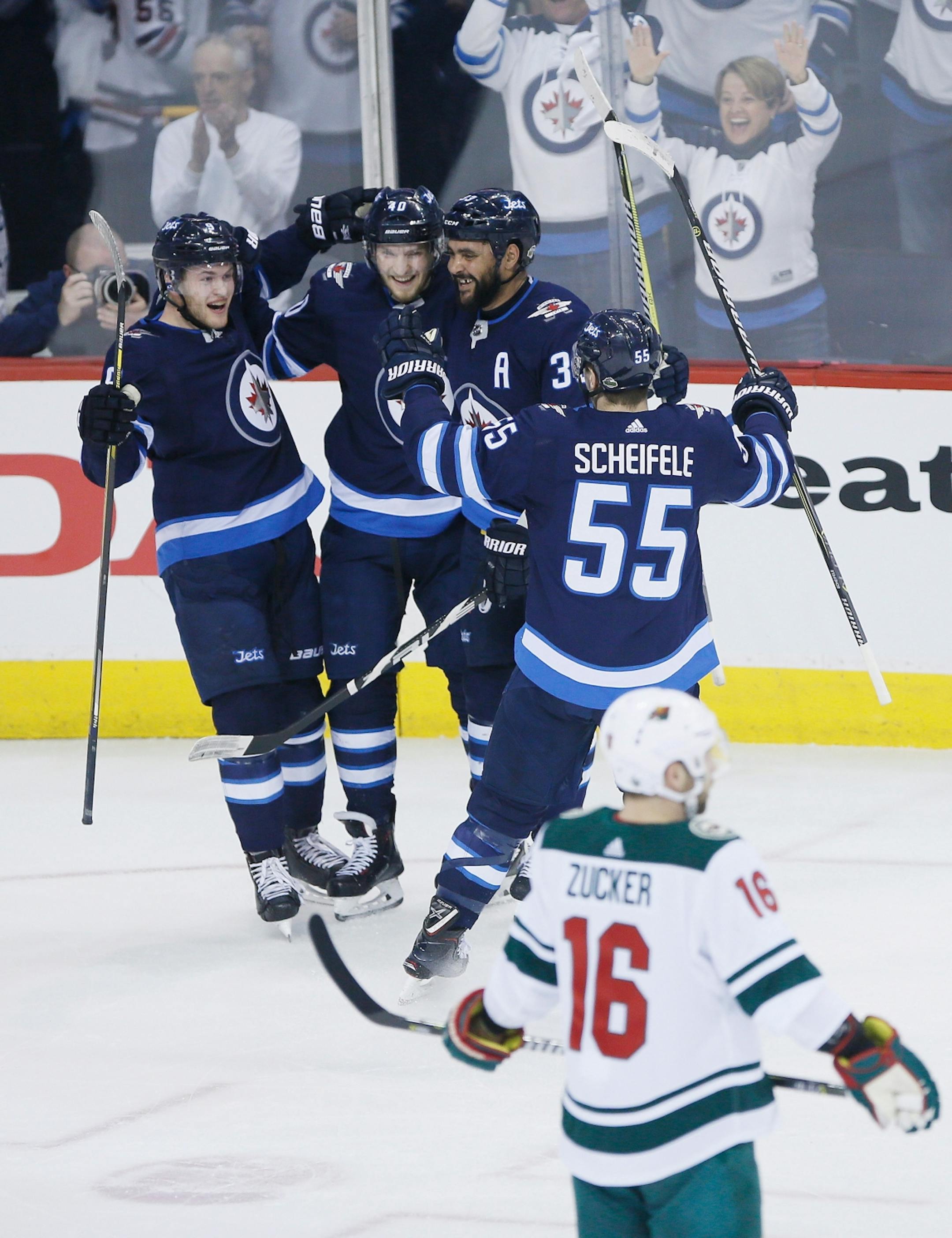 Winnipeg Jets' Andrew Copp (9), Joel Armia (40), Dustin Byfuglien (33) and Mark Scheifele (55) celebrate Armia's goal against the Minnesota Wild during the first period in Game 5 of an NHL hockey first-round playoff series in Winnipeg, Manitoba, Friday, April 20, 2018.