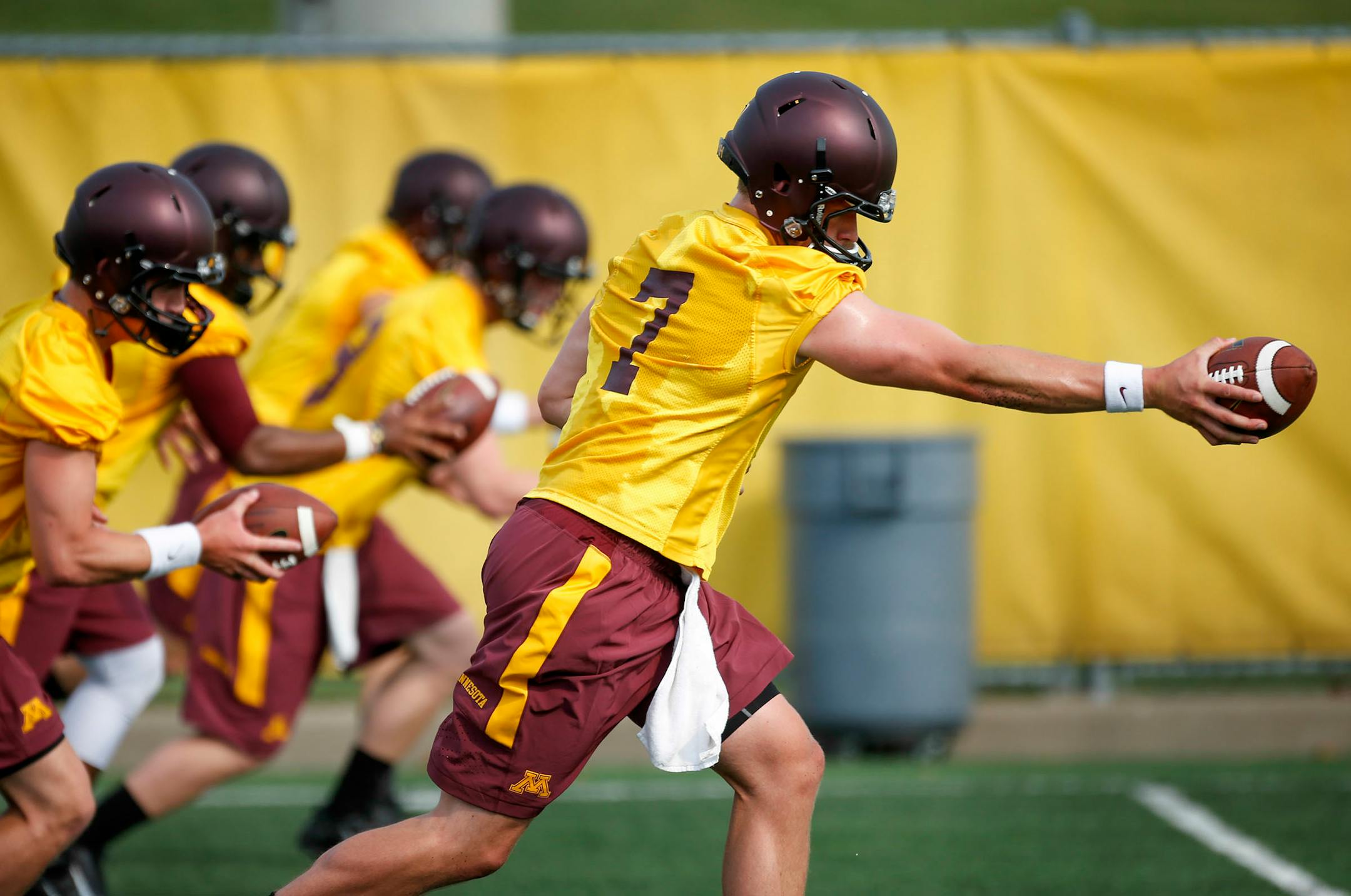 Mitch Leidner (7) worked on a handoff drill with fellow quarterbacks during Friday's opening practice. On Sunday, he had good moments, mixed with some bad, during practice.