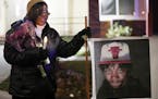 Irma Burns, the mother of Jamar Clark, leaned on a sign bearing a photo of her son during a vigil in November 2017.