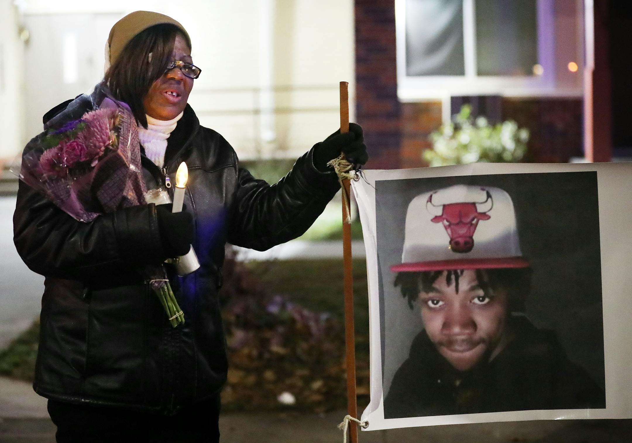 Irma Burns, the mother of Jamar Clark, leaned on a sign bearing a photo of her son during a vigil in November 2017.