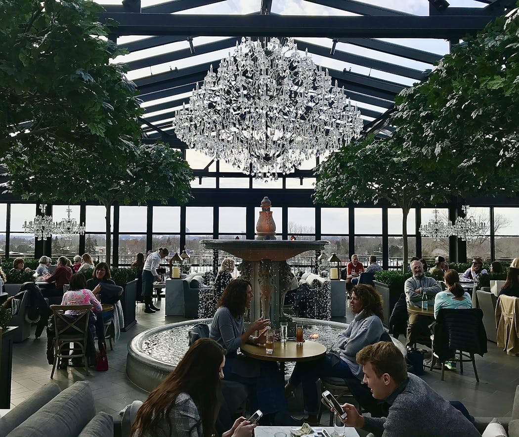 Windows and chandeliers make for an elegant rooftop dining experience at RH Rooftop Restaurant above the Restoration Hardware in Edina.