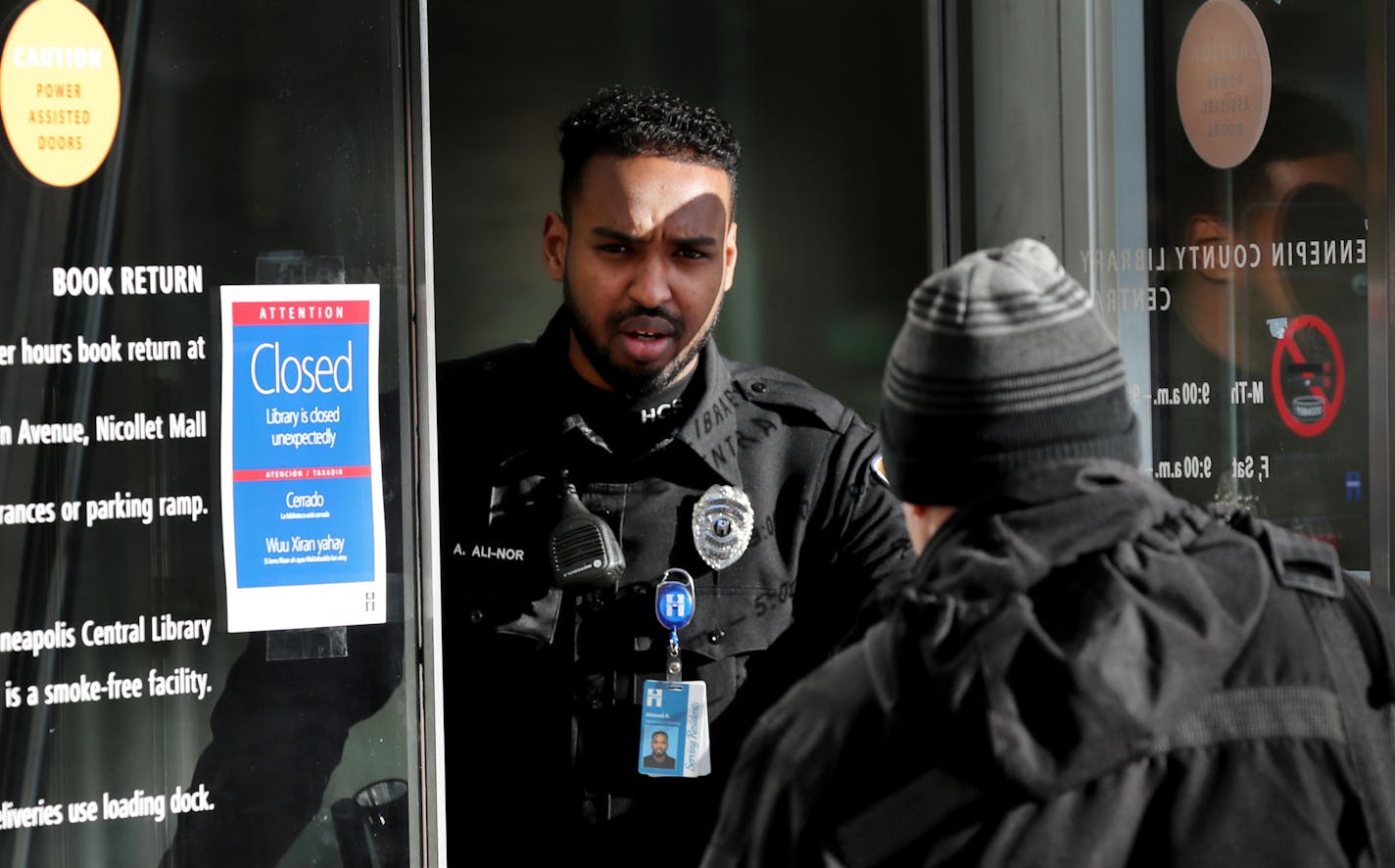 A security guard allows an employee into the downtown Minneapolis Public Library, where patrons were turned away after the library closed amid the Coronavirus spread Tuesday, March 17, 2020, in Minneapolis MN. Many use the library as a place to get out of the cold, some of those are homeless, during their day. "I'm not too worried about it," he said. "I still have some money in the bank." DAVID JOLES • david.joles@startribune.com Coronavirus